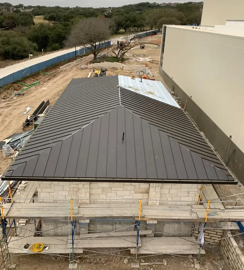 Metal roof new construction with scaffolding in Forest Park